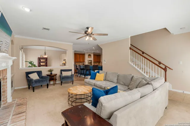 a living room with furniture ceiling fan and a rug