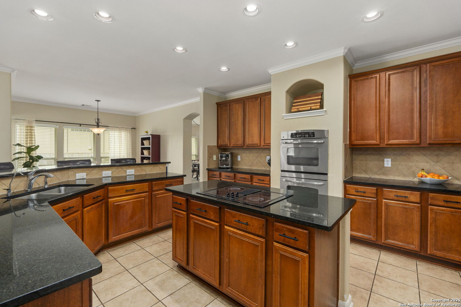 16106 Ponderosa Pth Helotes, TX 78023 - Photo 6 of 40 a kitchen with stainless steel appliances granite countertop wooden cabinets a sink and dishwasher