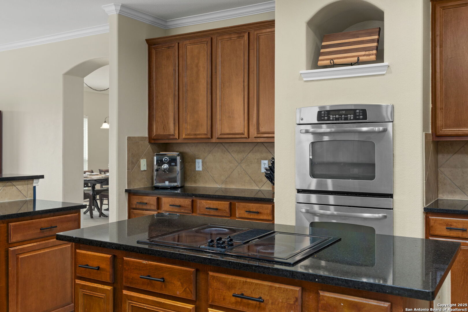 16106 Ponderosa Pth Helotes, TX 78023 - Photo 7 of 40 a kitchen with kitchen island granite countertop a stove and a sink