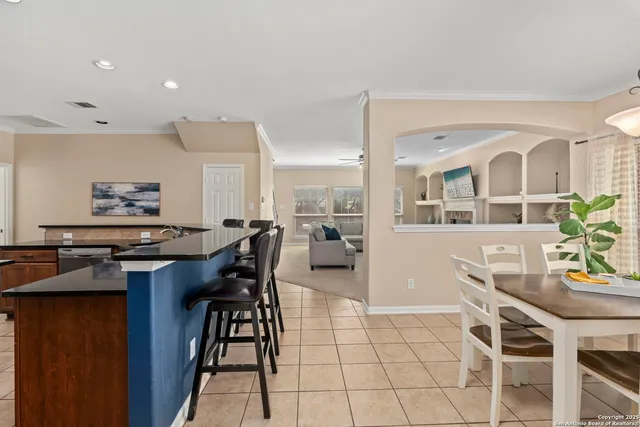 a view of a dining room with furniture and a potted plant