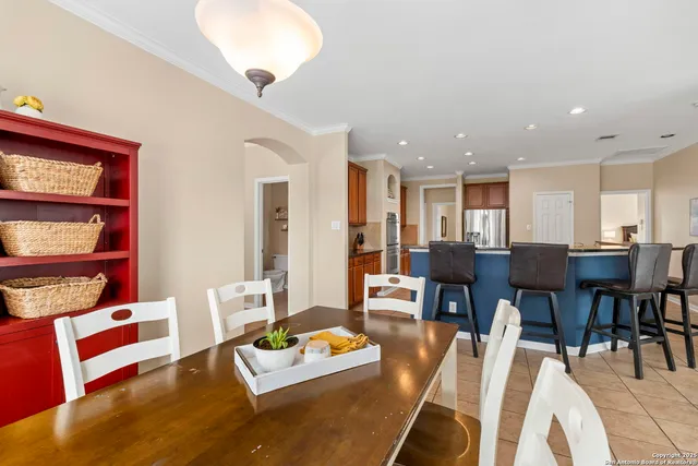 a living room with furniture and a dining table