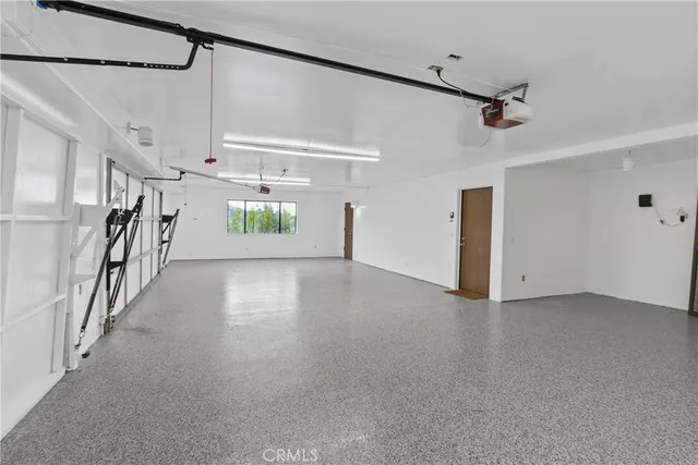 a view of hallway with stairs and wooden floor