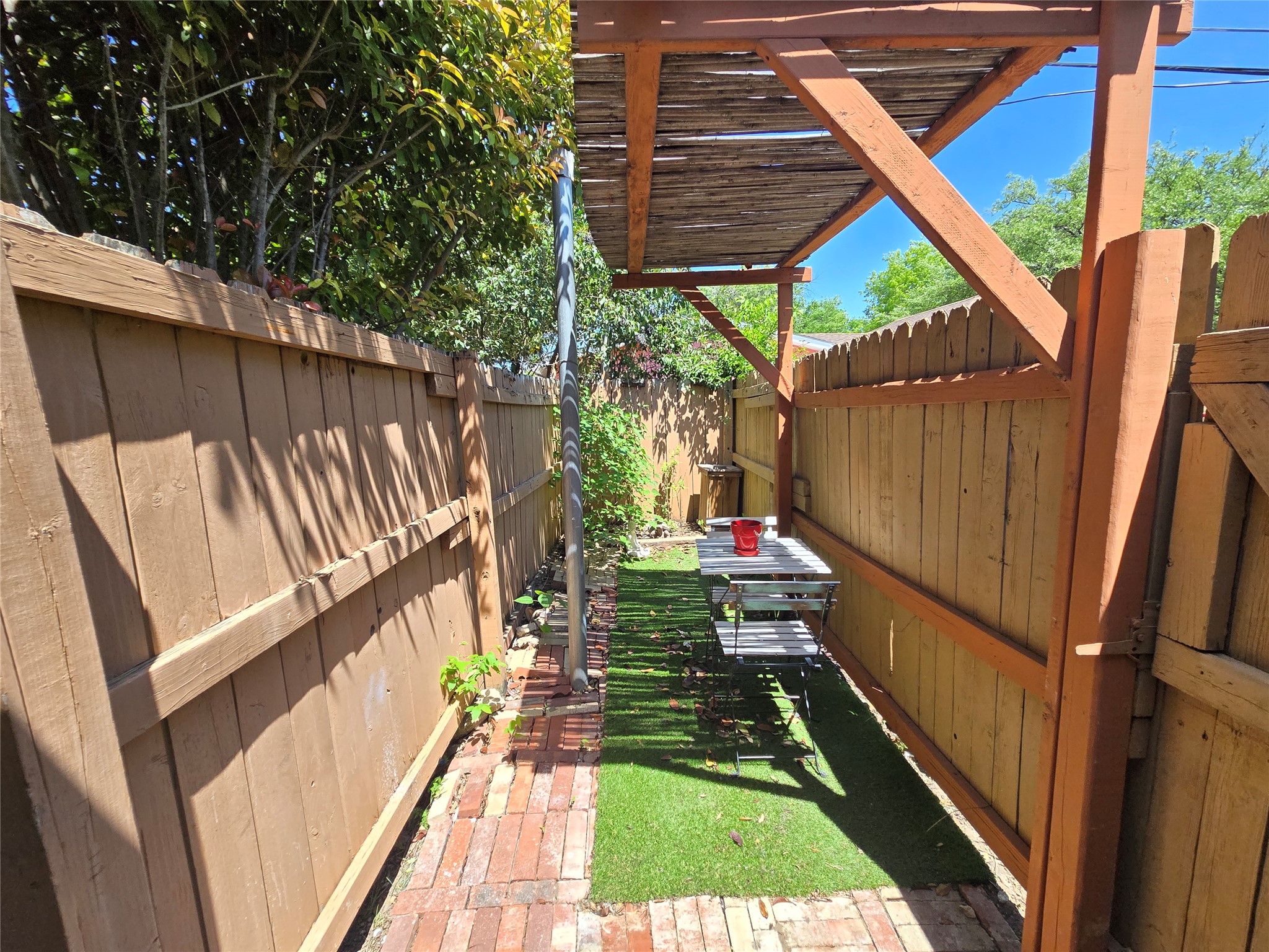 10605 Newmont Road, Unit B Austin, TX 78758 - Photo 2 of 10 View of private yard featuring a fenced backyard and a pergola