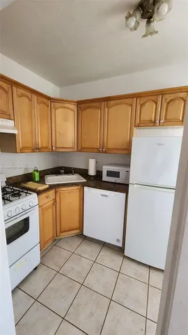 a kitchen with a stove a sink and a refrigerator