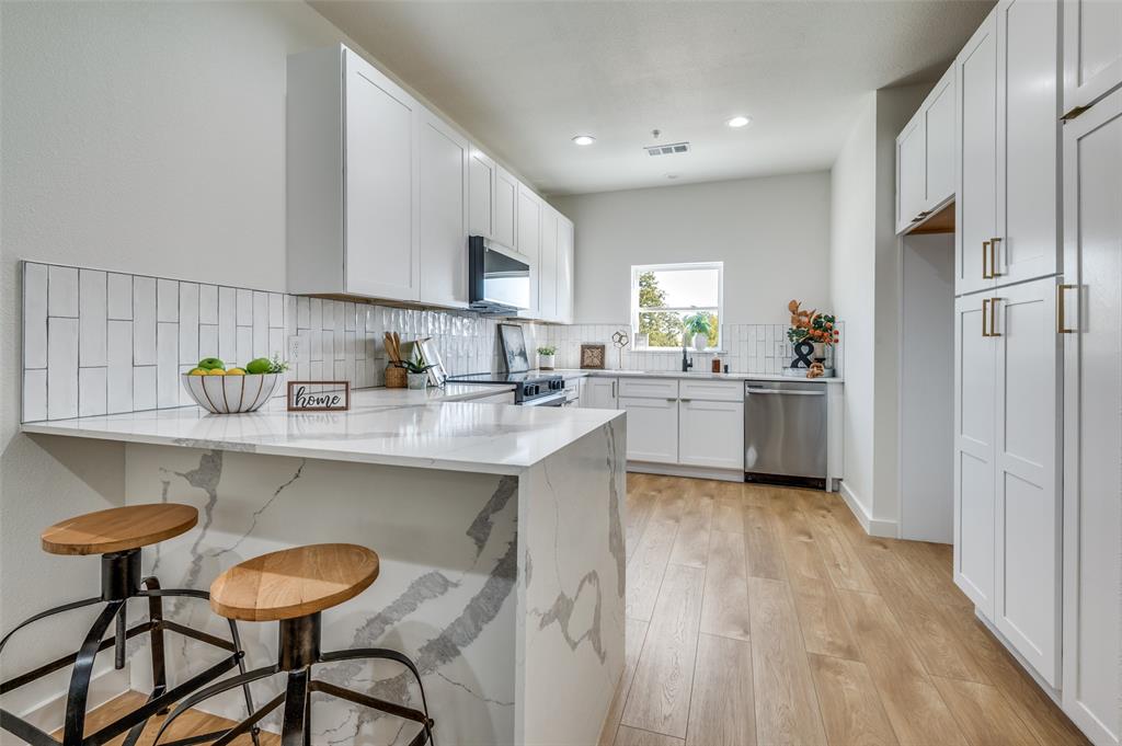 520 South O Connor Road Irving, TX 75060 - Photo 12 of 29 a kitchen with stainless steel appliances a sink stove and cabinets