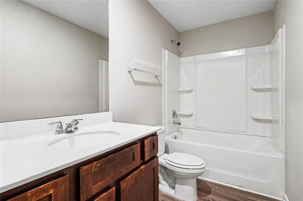 10941 Wheeler Trace Hampton, GA 30228 - Photo 20 of 21 a bathroom with a sink a toilet and a bathtub