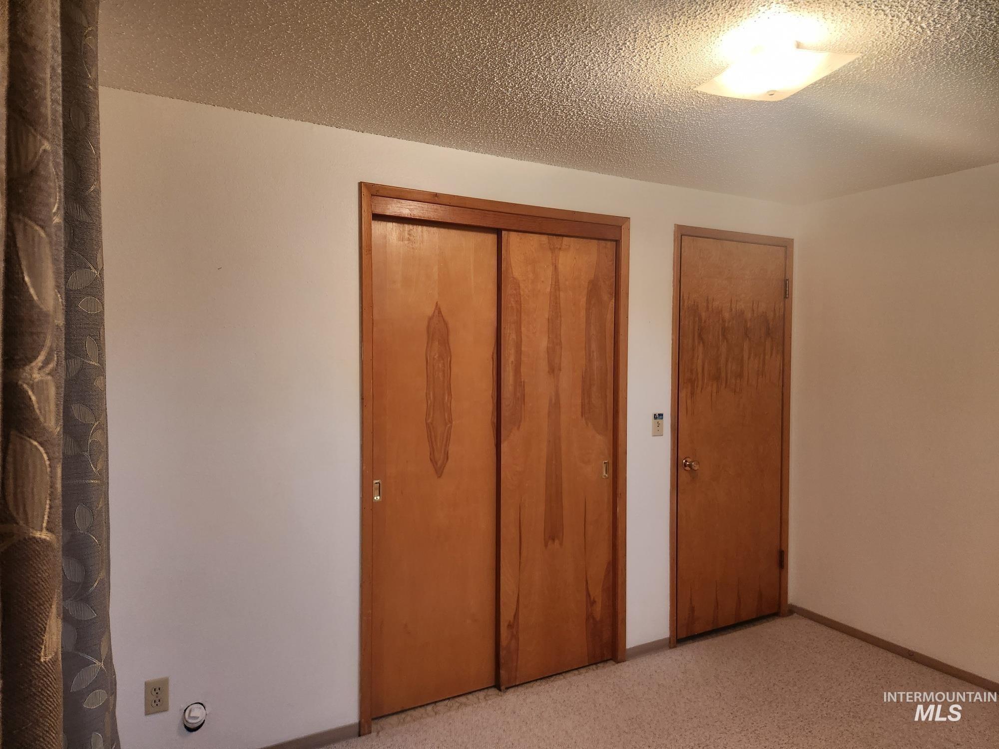 367 Woodland Road Kamiah, ID 83536 - Photo 22 of 45 Unfurnished bedroom with a textured ceiling and a closet