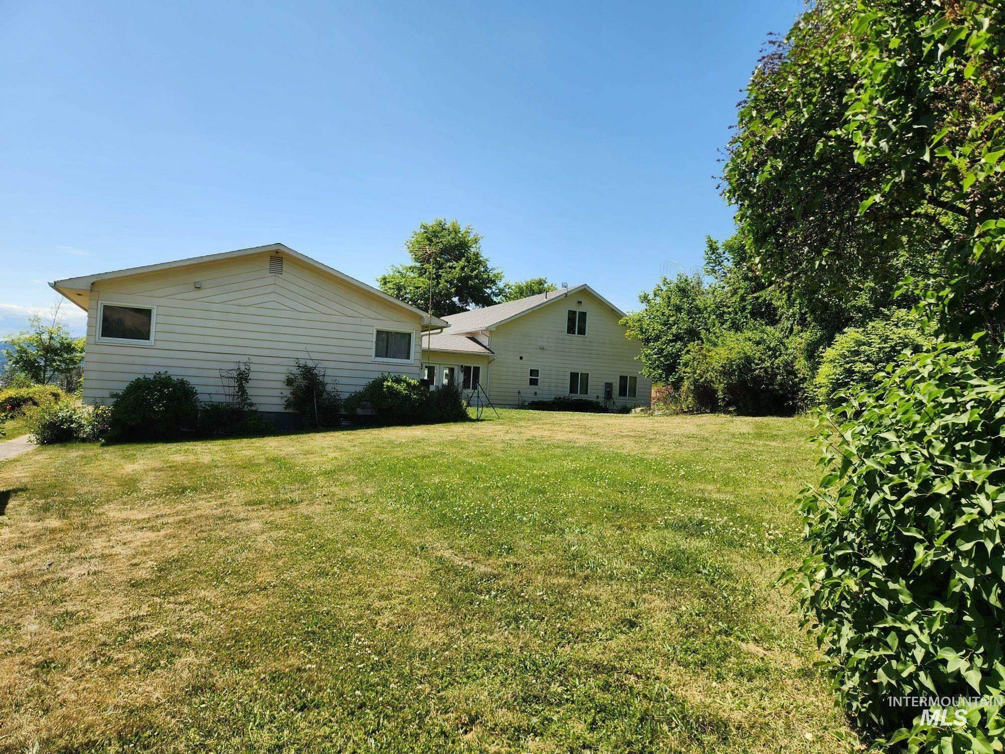 367 Woodland Road Kamiah, ID 83536 - Photo 41 of 45 Back of house featuring a lawn