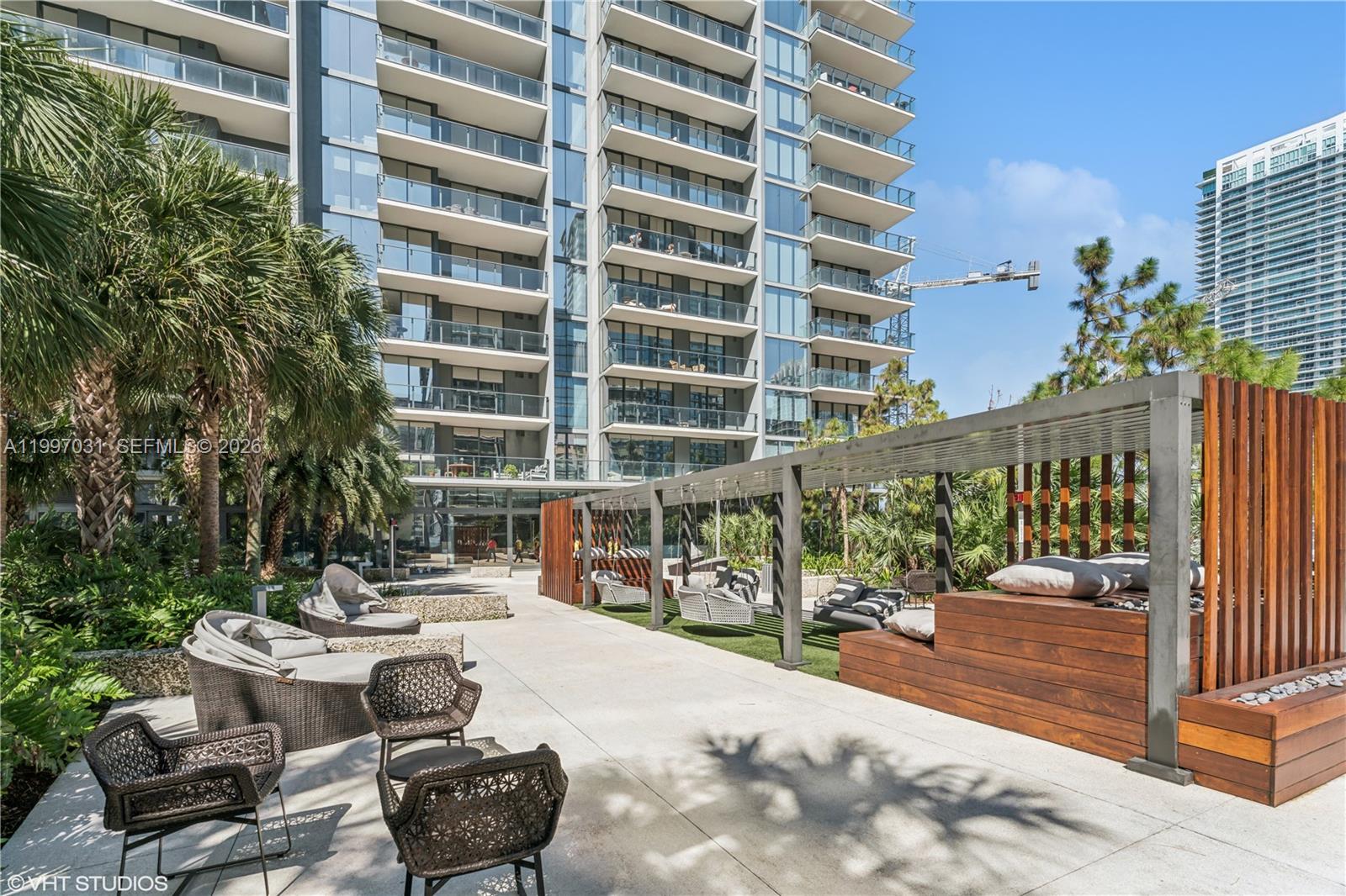 88 Southwest 7th Street, Unit 1804 Miami, FL 33130 - Photo 11 of 39 a view of a patio with couches table and chairs and potted plants