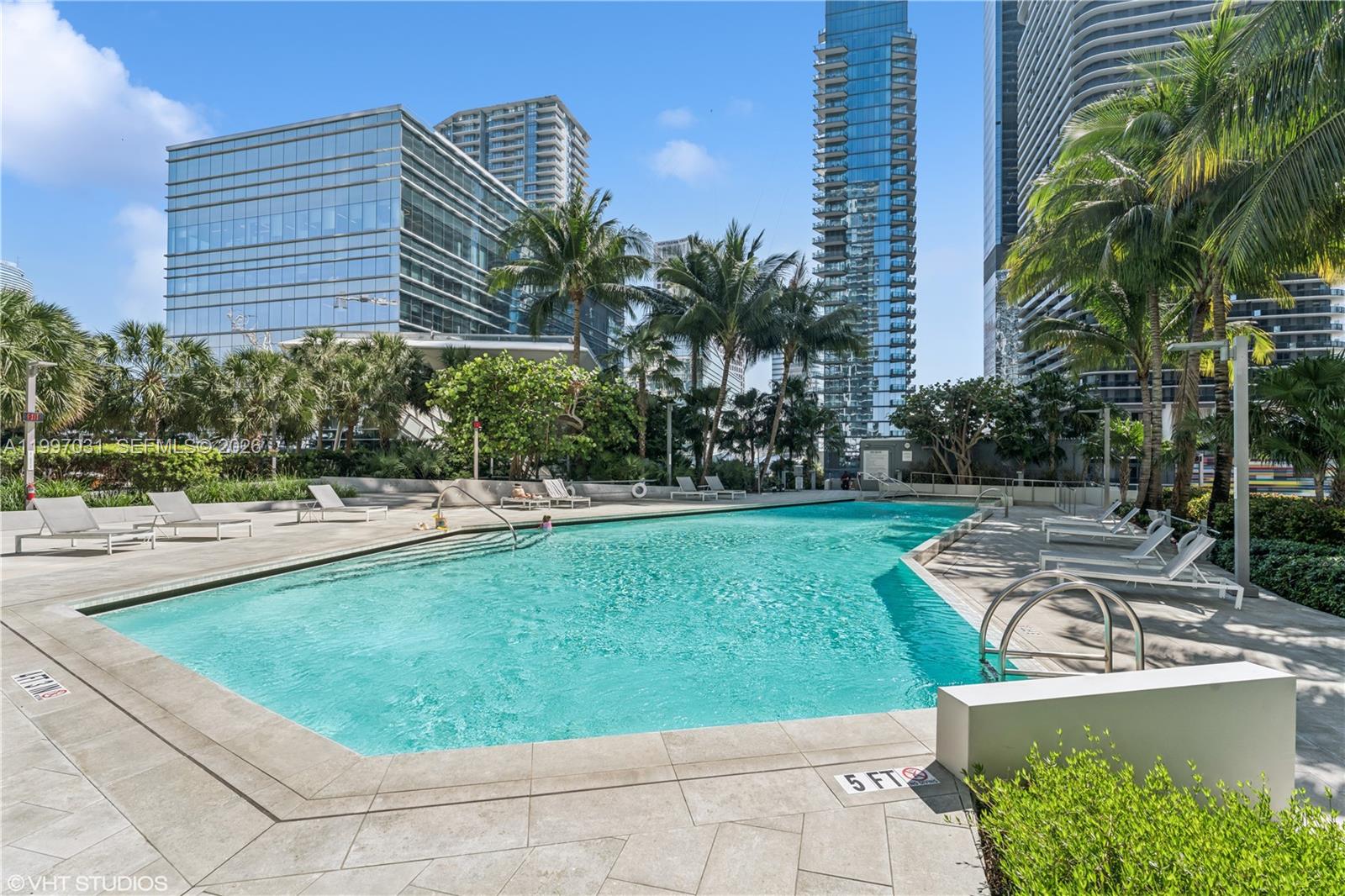 88 Southwest 7th Street, Unit 1804 Miami, FL 33130 - Photo 16 of 39 a view of a swimming pool with a patio