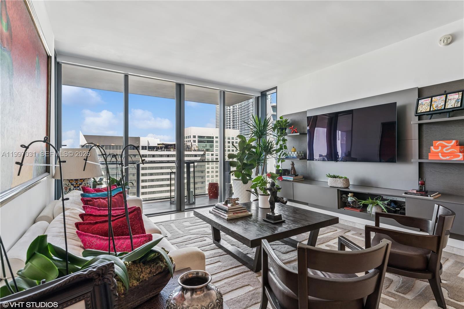 88 Southwest 7th Street, Unit 1804 Miami, FL 33130 - Photo 22 of 39 a living room with furniture and a flat screen tv
