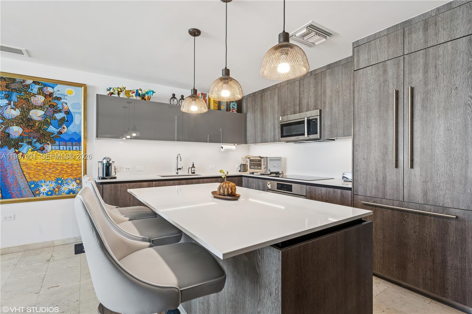 88 Southwest 7th Street, Unit 1804 Miami, FL 33130 - Photo 23 of 39 a kitchen with appliances cabinets and a table