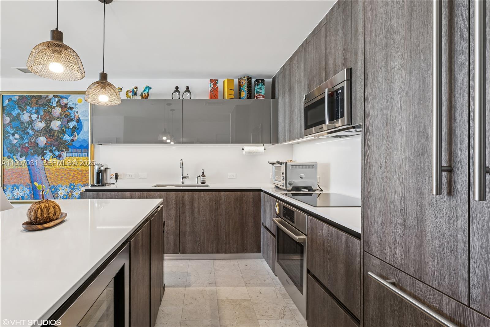 88 Southwest 7th Street, Unit 1804 Miami, FL 33130 - Photo 24 of 39 a kitchen with stainless steel appliances a sink and a stove
