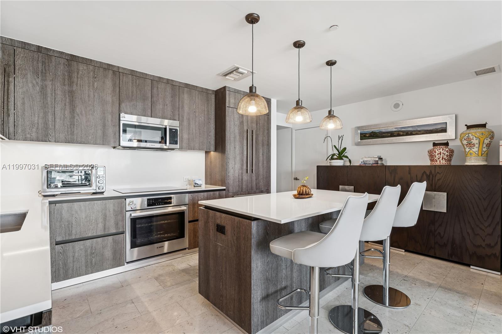 88 Southwest 7th Street, Unit 1804 Miami, FL 33130 - Photo 25 of 39 a kitchen with a dining table chairs and white cabinets