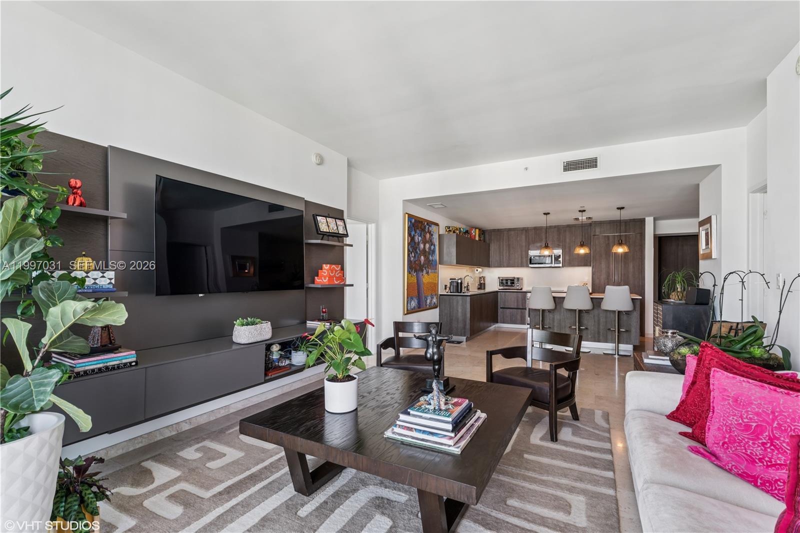 88 Southwest 7th Street, Unit 1804 Miami, FL 33130 - Photo 27 of 39 a living room with furniture potted plant and a window