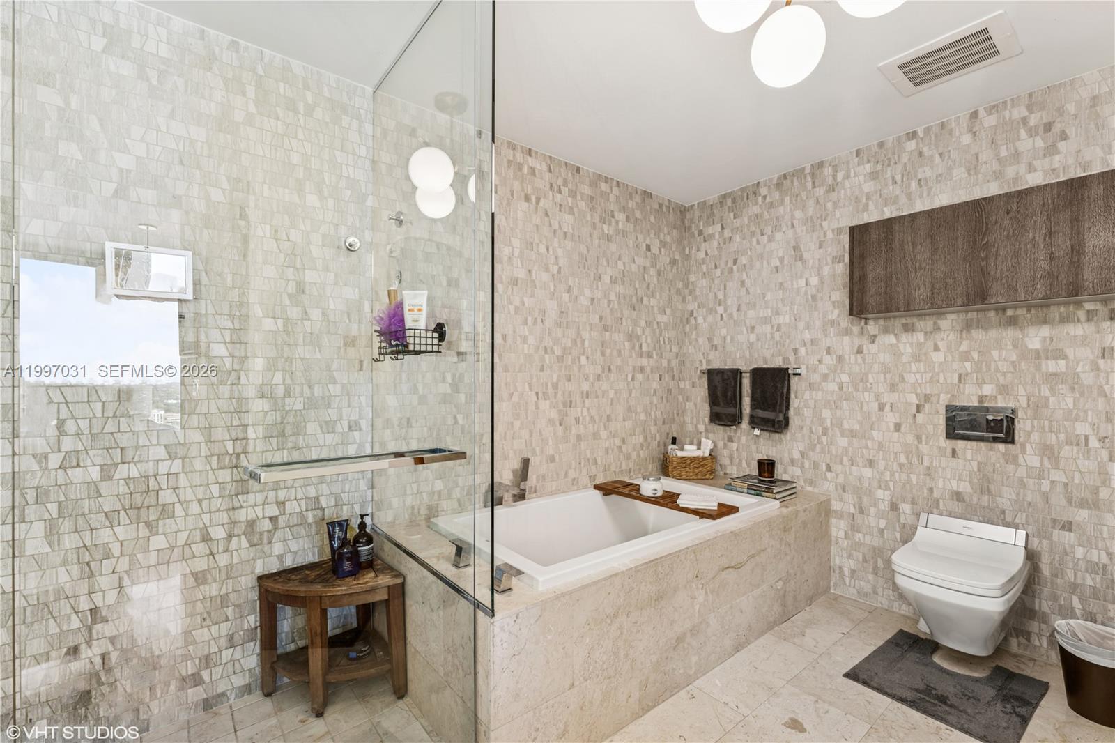 88 Southwest 7th Street, Unit 1804 Miami, FL 33130 - Photo 29 of 39 a bathroom with a sink a toilet and mirror