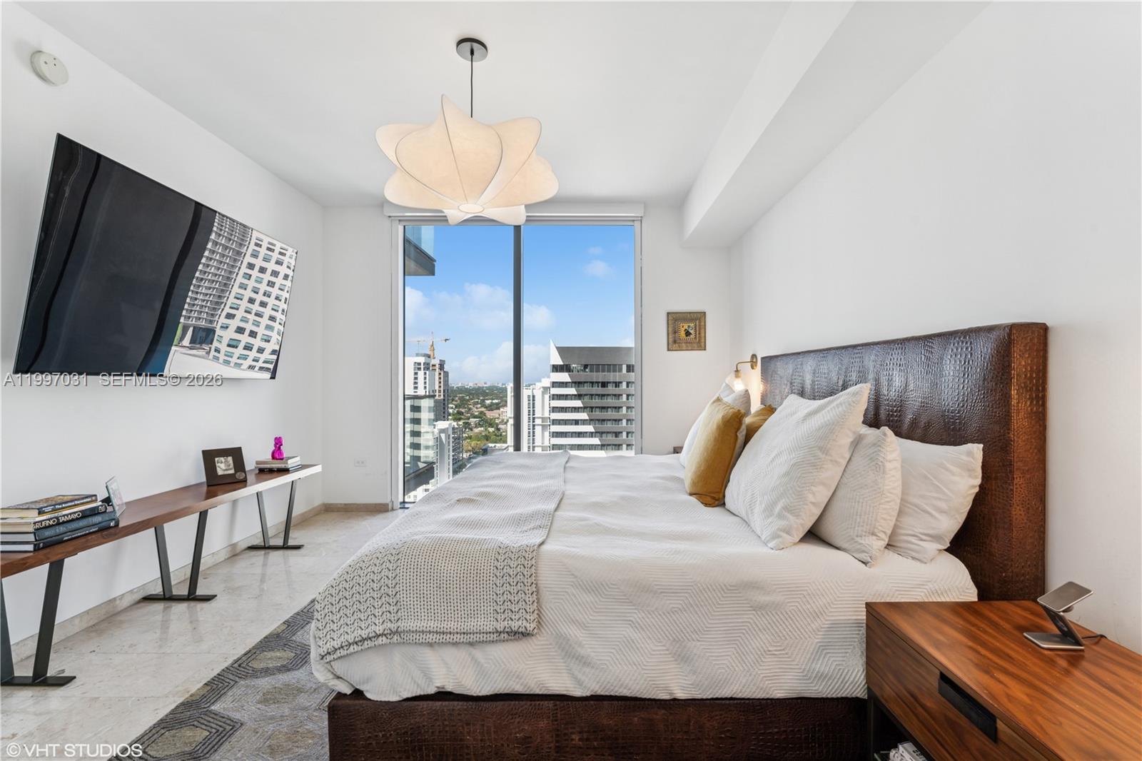 88 Southwest 7th Street, Unit 1804 Miami, FL 33130 - Photo 31 of 39 a bedroom with a bed and a flat screen tv