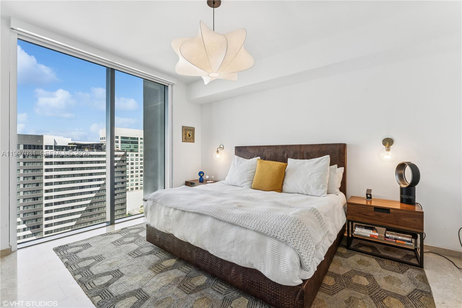 88 Southwest 7th Street, Unit 1804 Miami, FL 33130 - Photo 32 of 39 a bedroom with a large bed and a window
