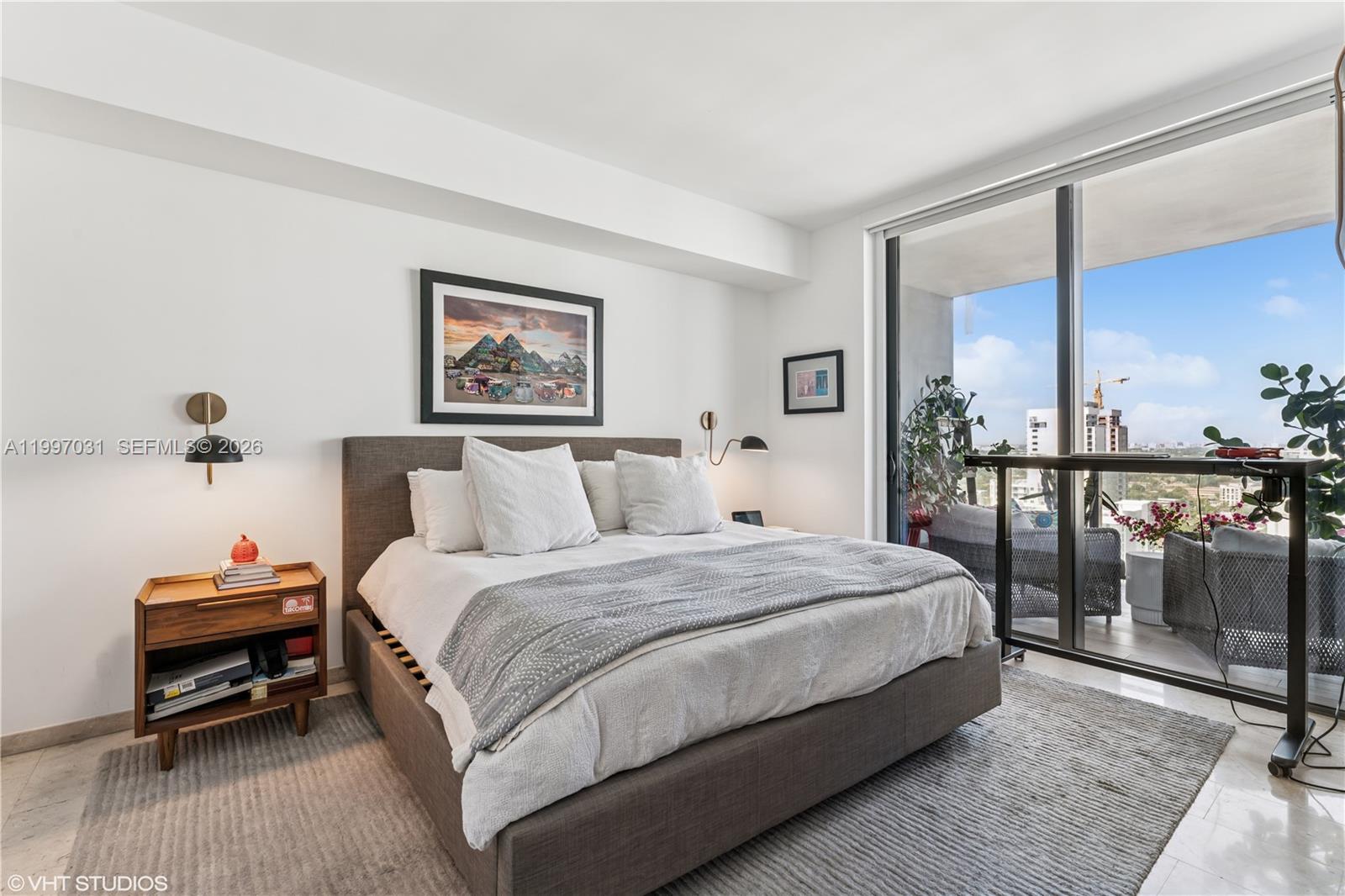 88 Southwest 7th Street, Unit 1804 Miami, FL 33130 - Photo 33 of 39 a spacious bedroom with a bed and a desk