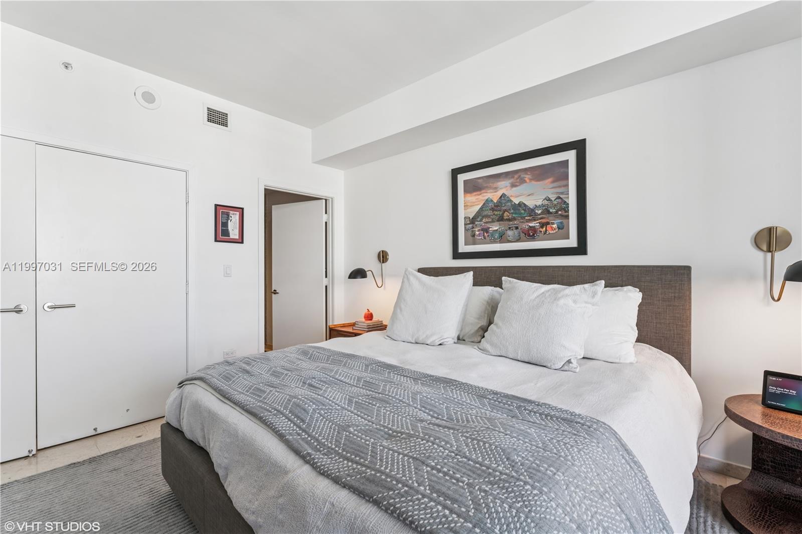 88 Southwest 7th Street, Unit 1804 Miami, FL 33130 - Photo 35 of 39 a bedroom with a bed and a painting on the wall