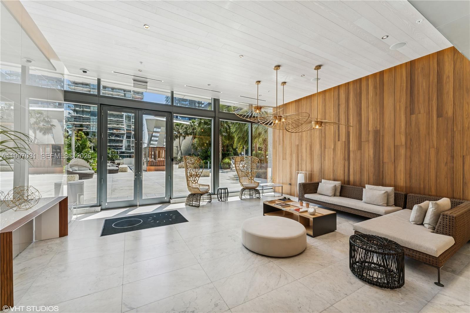 88 Southwest 7th Street, Unit 1804 Miami, FL 33130 - Photo 4 of 39 a living room with furniture and a large window