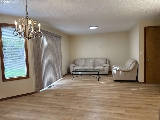 a living room with furniture and a chandelier