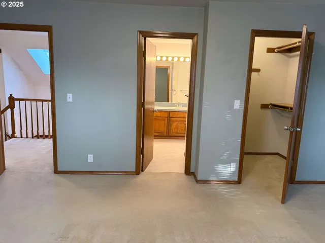 an empty room with closet and windows