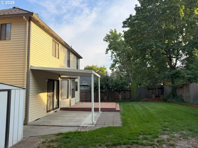 a view of a house with a yard and sitting area