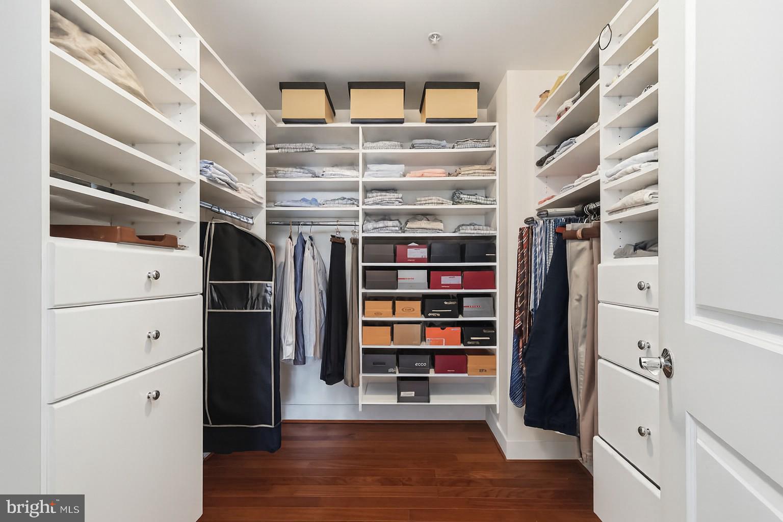 2425 L Street Northwest, Unit 303 Washington, DC 20037 - Photo 17 of 37 a view of walk in closet with clothes and shoes
