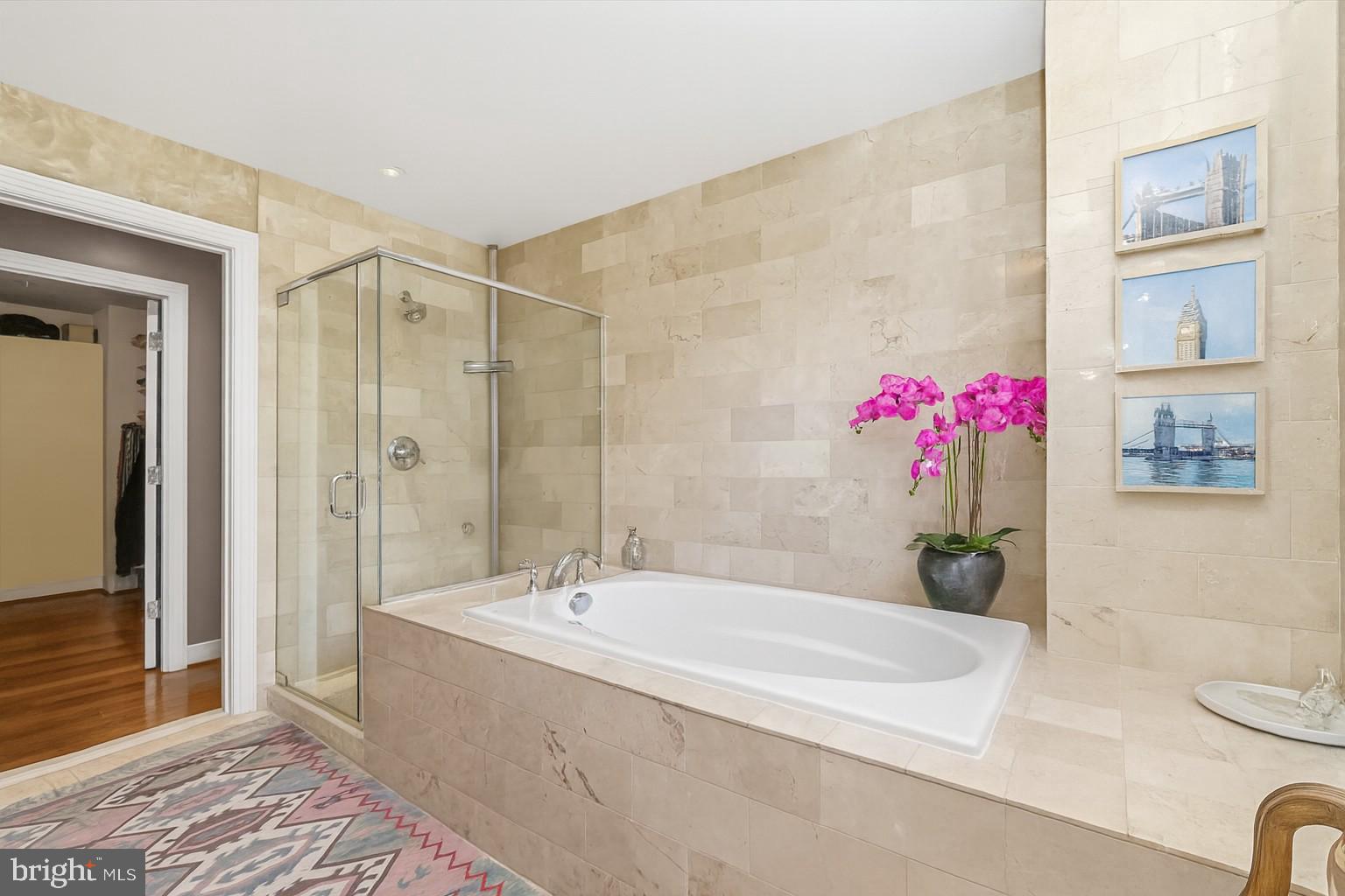 2425 L Street Northwest, Unit 303 Washington, DC 20037 - Photo 19 of 37 a bathroom with a tub a sink and a shower