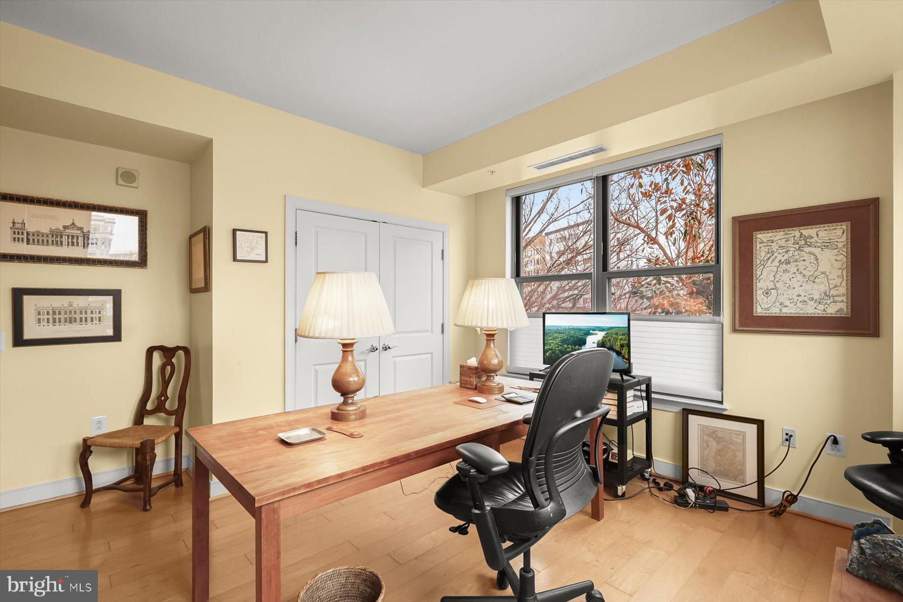2425 L Street Northwest, Unit 303 Washington, DC 20037 - Photo 22 of 37 a view of a workspace with furniture and a window