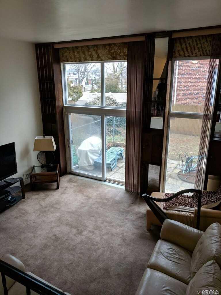 258-16 149th Road Queens, NY 11422 - Photo 6 of 11 a living room with furniture and a flat screen tv