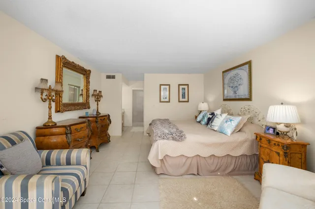 a bedroom with a bed and couch