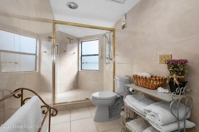 a bathroom with a sink mirror toilet and shower