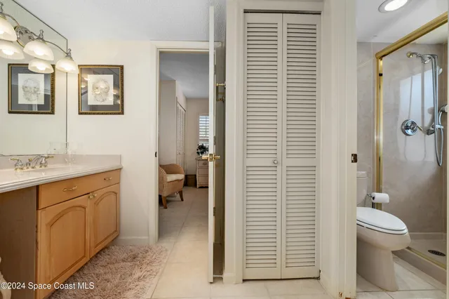 a bathroom with a toilet a sink and shower