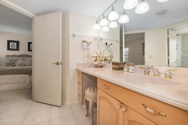 a bathroom with a sink vanity and a mirror