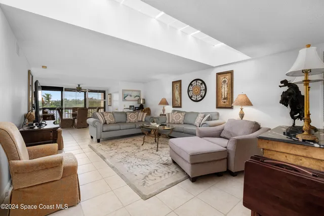 a living room with furniture and a mirror