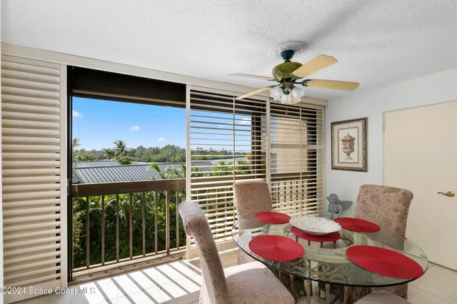 a view of a dining room with furniture wooden floor and a chandelier