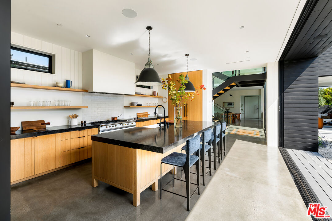 901 Flower Avenue Venice, CA 90291 - Photo 11 of 35 a kitchen with stainless steel appliances granite countertop a stove and a sink