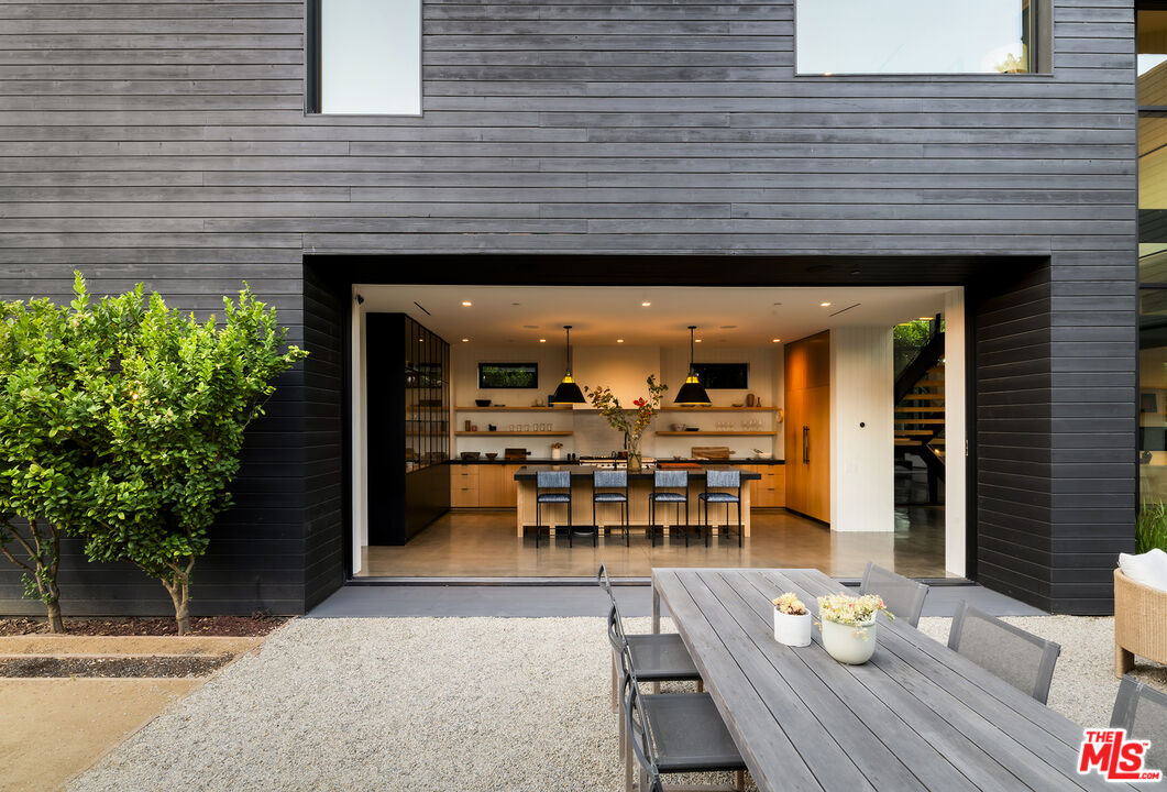 901 Flower Avenue Venice, CA 90291 - Photo 12 of 35 a view of a patio with table and chairs potted plants and floor to ceiling window