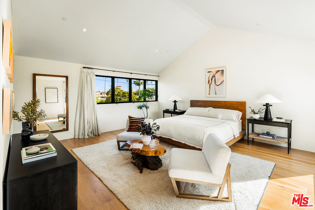 901 Flower Avenue Venice, CA 90291 - Photo 18 of 35 a bedroom with a bed and wooden floor