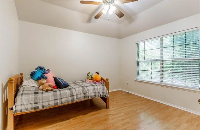 a view of a room with wooden floor and a window
