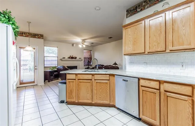 a kitchen with white cabinets and appliances