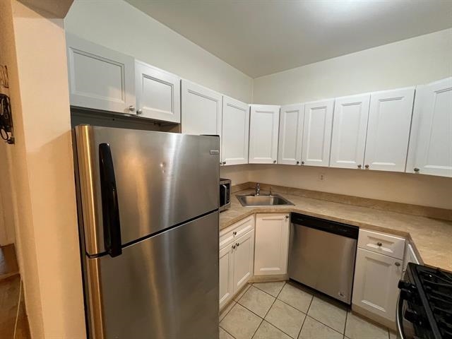 58 Madison Street, Unit 2 Hoboken, NJ 07030 - Photo 11 of 28 a white refrigerator freezer sitting in a kitchen