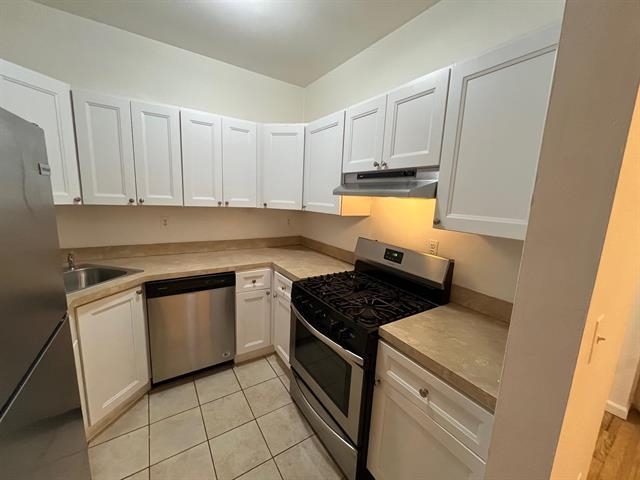 58 Madison Street, Unit 2 Hoboken, NJ 07030 - Photo 12 of 28 a kitchen with white cabinets and appliances