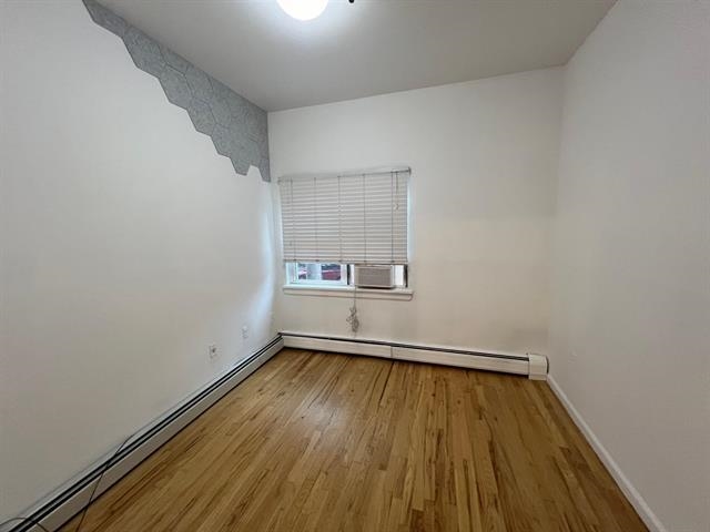 58 Madison Street, Unit 2 Hoboken, NJ 07030 - Photo 15 of 28 a view of room with wooden floor and white walls