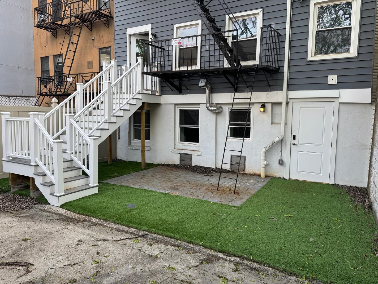 58 Madison Street, Unit 2 Hoboken, NJ 07030 - Photo 2 of 28 a view of a house with a yard and wooden fence
