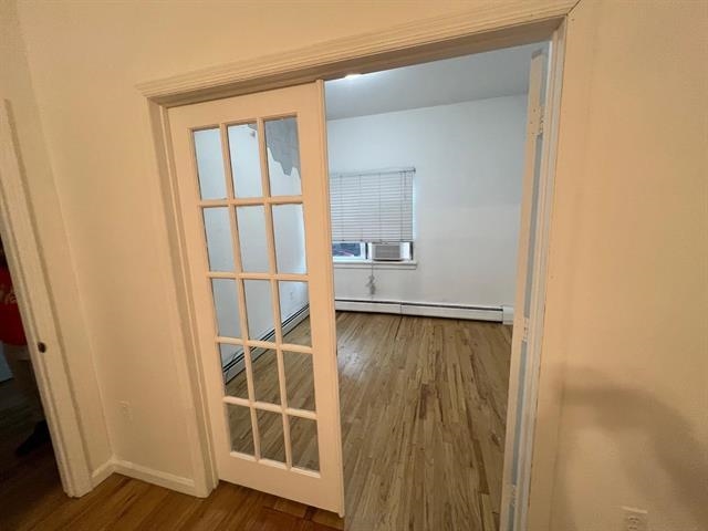 58 Madison Street, Unit 2 Hoboken, NJ 07030 - Photo 9 of 28 an empty room with wooden floor and entrance