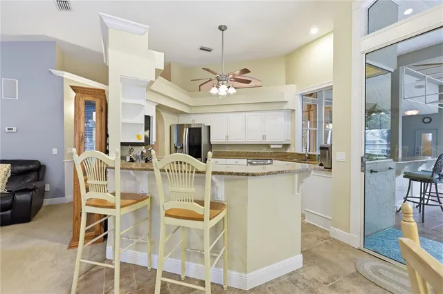 a view of a dining room with furniture and a chandelier