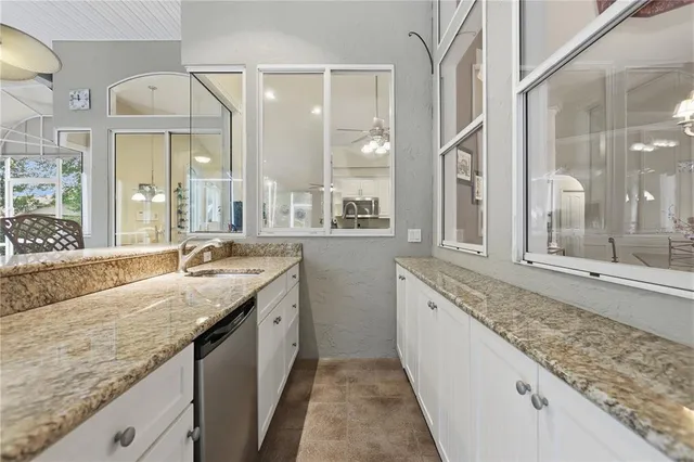 a bathroom with a granite countertop sink and a large mirror